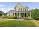 Charming two-story home featuring a welcoming front porch with classic columns and a well-manicured lawn at 4769 Swordfish Dr, Raleigh, NC 27603