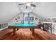 Finished attic space featuring a game room with pool table, seating area, and unique decor at 4769 Swordfish Dr, Raleigh, NC 27603