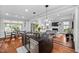 Open-concept kitchen featuring granite island, stainless steel appliances, and views into the adjacent living area at 4769 Swordfish Dr, Raleigh, NC 27603
