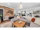 Inviting living room featuring a rustic wood accent wall, a plush gray sectional, and an open layout at 4769 Swordfish Dr, Raleigh, NC 27603