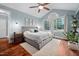 Serene main bedroom with a vaulted ceiling, hardwood floors, and a large window overlooking the yard at 4769 Swordfish Dr, Raleigh, NC 27603