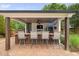 Outdoor bar area with seating, a television, and a ceiling fan for relaxation at 4769 Swordfish Dr, Raleigh, NC 27603