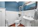 Charming powder room with stylish wainscoting and a pedestal sink at 4769 Swordfish Dr, Raleigh, NC 27603
