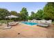 Backyard with swimming pool, lounge chairs, and landscaped surroundings at 4769 Swordfish Dr, Raleigh, NC 27603