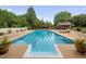 Beautiful swimming pool with lounge chairs, cabana, and lush landscaping at 4769 Swordfish Dr, Raleigh, NC 27603