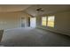 Open-concept living space with plush carpeting, a modern ceiling fan, and natural light streaming through large windows at 48 Pate Landing Dr, Selma, NC 27576