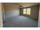 Serene primary bedroom features neutral carpeting, ceiling fan, and bright windows, providing a peaceful retreat at 48 Pate Landing Dr, Selma, NC 27576