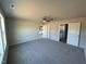 Spacious bedroom featuring plush carpeting, a ceiling fan, and convenient access to both the bathroom and kitchen at 48 Pate Landing Dr, Selma, NC 27576