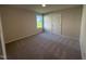 Bright carpeted bedroom with a window, neutral paint and a closet at 49 Heatherglenn Cir, Princeton, NC 27569