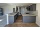 Modern kitchen featuring dark cabinets, granite countertops, stainless steel appliances, and wood flooring at 49 Heatherglenn Cir, Princeton, NC 27569