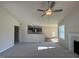 Bright living room featuring vaulted ceilings and an open concept layout to the kitchen area at 49 Heatherglenn Cir, Princeton, NC 27569