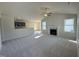 Bright living room with a fireplace, vaulted ceilings, and an open concept layout to the kitchen area at 49 Heatherglenn Cir, Princeton, NC 27569