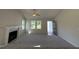 Bright living room featuring a fireplace, vaulted ceilings, and open doorway to front entryway at 49 Heatherglenn Cir, Princeton, NC 27569
