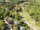 Aerial view of homes nestled amidst lush green trees and the golf course at 4912 Sunset Forest Cir, Holly Springs, NC 27540