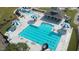 Aerial view of the community pool and recreation center with umbrellas and lounge chairs at 4912 Sunset Forest Cir, Holly Springs, NC 27540