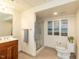 The bathroom features a wood vanity, walk-in shower, and decorative art at 4912 Sunset Forest Cir, Holly Springs, NC 27540