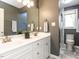 This bathroom features a double sink vanity, tile floors, and a glass shower at 4912 Sunset Forest Cir, Holly Springs, NC 27540
