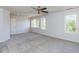 Spacious bedroom with plush carpeting, multiple windows, and ample natural light at 4912 Sunset Forest Cir, Holly Springs, NC 27540
