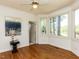 Bright bedroom with hardwood floors, large windows, and serene views of the outdoors at 4912 Sunset Forest Cir, Holly Springs, NC 27540