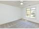 A bright bedroom with a large window and neutral carpet is a blank canvas at 4912 Sunset Forest Cir, Holly Springs, NC 27540