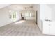 Bright and airy bonus room with neutral carpet and a convenient wet bar at 4912 Sunset Forest Cir, Holly Springs, NC 27540