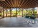 Inviting covered deck with wood floors and ceiling, golf course view, and comfortable seating arrangement at 4912 Sunset Forest Cir, Holly Springs, NC 27540