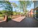 Spacious wooden deck perfect for entertaining with a stainless steel grill and wooded views at 4912 Sunset Forest Cir, Holly Springs, NC 27540