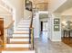 Bright foyer with hardwood floors, staircase with decorative wrought iron, and soaring ceilings at 4912 Sunset Forest Cir, Holly Springs, NC 27540