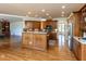 Large kitchen with island, stainless appliances, hardwood floors, and ample counter space at 4912 Sunset Forest Cir, Holly Springs, NC 27540