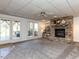 Cozy living room with stone fireplace and access to the outdoor deck at 4912 Sunset Forest Cir, Holly Springs, NC 27540