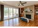 Cozy living room with a stone fireplace, custom built-ins, and access to the outdoor deck at 4912 Sunset Forest Cir, Holly Springs, NC 27540