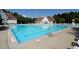 Outdoor community pool with plenty of lounge chairs for relaxing and soaking up the sun at 4912 Sunset Forest Cir, Holly Springs, NC 27540