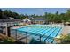 Large community pool with lap lanes, sun loungers, and covered seating areas at 4912 Sunset Forest Cir, Holly Springs, NC 27540