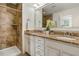 Elegant bathroom featuring double sinks, granite countertops, and a tiled shower at 518 Oak Forest View Ln, Wake Forest, NC 27587