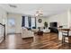 Spacious living room featuring hardwood floors, a ceiling fan, and ample natural light at 518 Oak Forest View Ln, Wake Forest, NC 27587