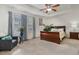 Serene primary bedroom with a tray ceiling, ceiling fan, and lots of natural light at 518 Oak Forest View Ln, Wake Forest, NC 27587