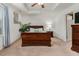 Spacious primary bedroom with a tray ceiling, carpeted floor and two nightstands at 518 Oak Forest View Ln, Wake Forest, NC 27587