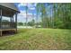 Expansive backyard featuring green grass, a screened porch, and privacy, ideal for relaxation and outdoor activities at 518 Ranch Farm Rd, Raleigh, NC 27603