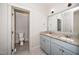 A bathroom with double vanity sinks, granite countertops, and a door leading to the toilet and shower at 518 Ranch Farm Rd, Raleigh, NC 27603