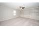 Finished attic bedroom with carpet, built-in storage, fan, and natural light from a window at 518 Ranch Farm Rd, Raleigh, NC 27603