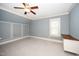 Spacious bedroom with a ceiling fan, light grey walls, white trim, and a small desk at 518 Ranch Farm Rd, Raleigh, NC 27603