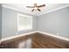 Bedroom with hardwood flooring, neutral paint, ceiling fan, and baseboard trim at 518 Ranch Farm Rd, Raleigh, NC 27603