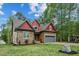 Charming exterior view showcasing the home's stone and siding details, plus an attached garage at 518 Ranch Farm Rd, Raleigh, NC 27603