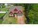 Beautiful home showcasing meticulous landscaping, a gray garage door, and verdant lawn at 518 Ranch Farm Rd, Raleigh, NC 27603