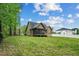 Back exterior of home with an expansive grassy area, screened porch, and privacy fence at 518 Ranch Farm Rd, Raleigh, NC 27603