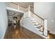 Spacious foyer with hardwood floors, a staircase with white railings, and a view of the living room at 518 Ranch Farm Rd, Raleigh, NC 27603
