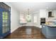 Eat-in kitchen with view into breakfast area, stainless appliances, granite countertops, and hardwood flooring at 518 Ranch Farm Rd, Raleigh, NC 27603