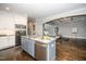 Eat-in kitchen island with granite countertops, stainless appliances, and hardwood flooring at 518 Ranch Farm Rd, Raleigh, NC 27603