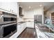 Spacious eat-in kitchen featuring stainless steel appliances, granite countertops, and white cabinets at 518 Ranch Farm Rd, Raleigh, NC 27603