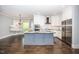 Bright eat-in kitchen featuring a gray island, white cabinets, and stainless steel appliances at 518 Ranch Farm Rd, Raleigh, NC 27603